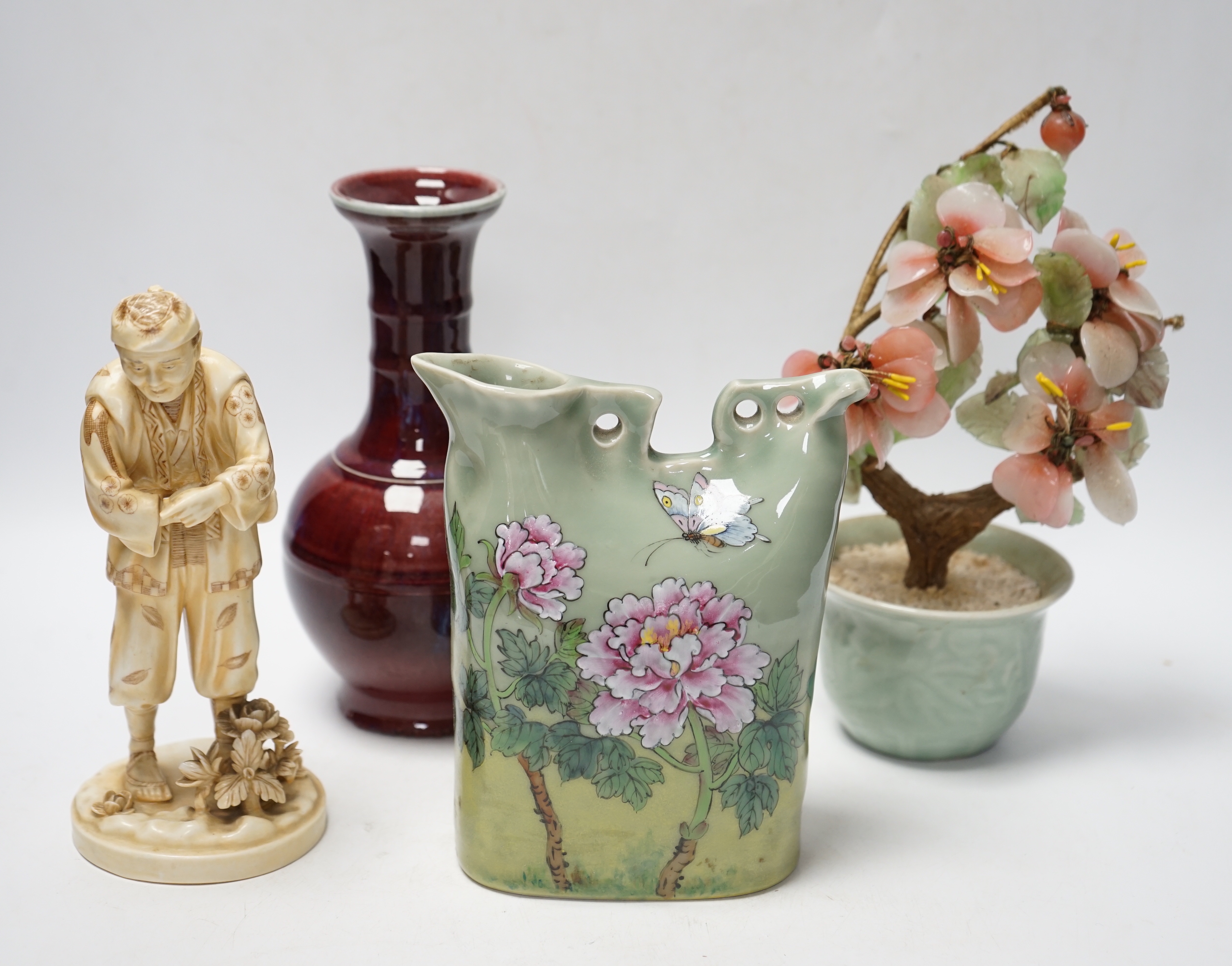 A Chinese flambé vase, famille rose jug, celadon plant pot and a Japanese porcelain figure, tallest 23cm